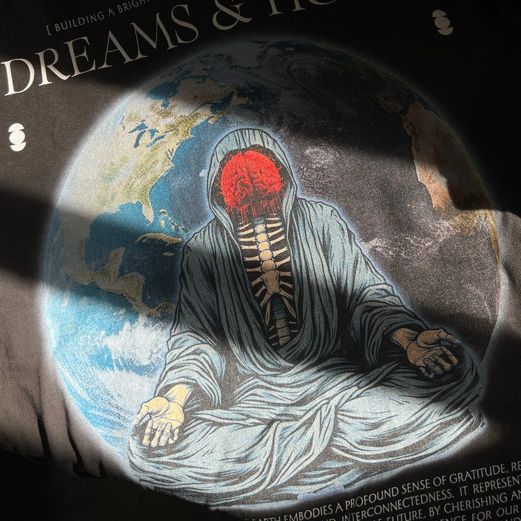 A Wandering Mind Dreams and Hopes long sleeve t-shirt in vintage black front graphic detail featuring robed figure, exposed brain, globe