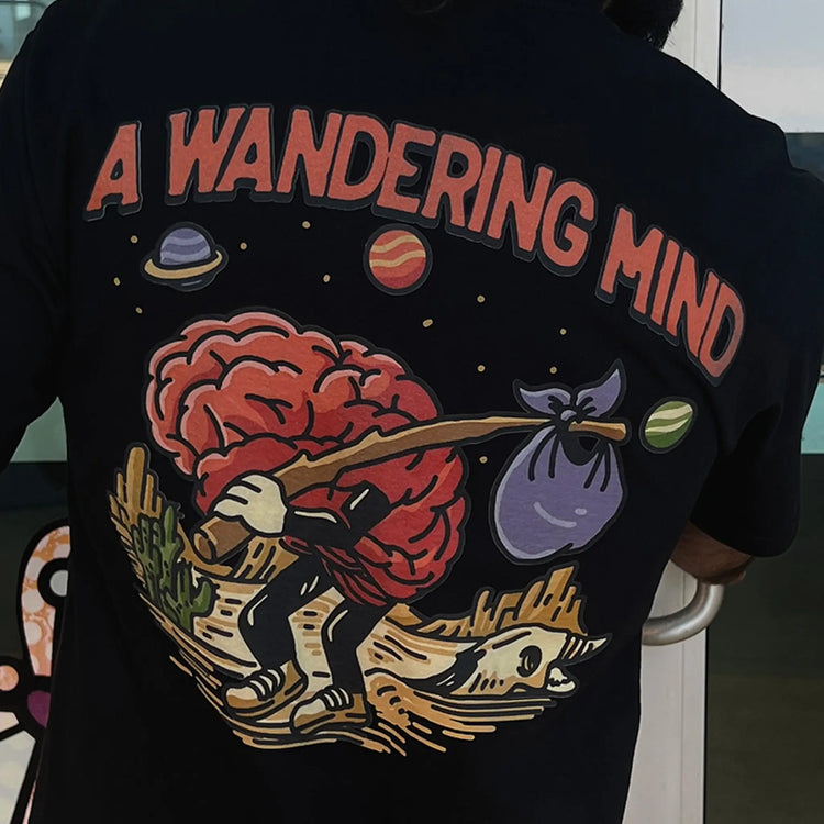 A Wandering Mind Arid Thoughts t-shirt in black back graphic featuring wandering brain character, desert, skull