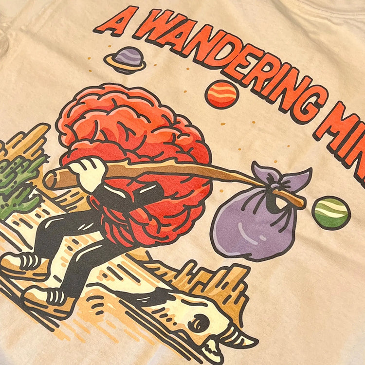 A Wandering Mind Arid Thoughts t-shirt in sand back graphic detail showing wandering brain character, desert, skull