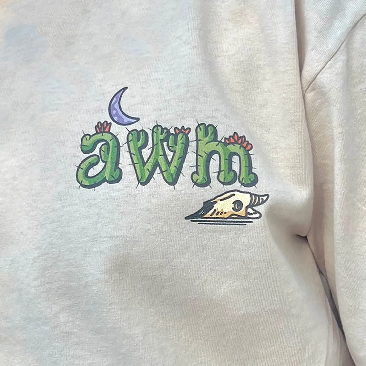 A Wandering Mind Arid Thoughts t-shirt in sand front graphic detail showing cactus typography, moon, skull