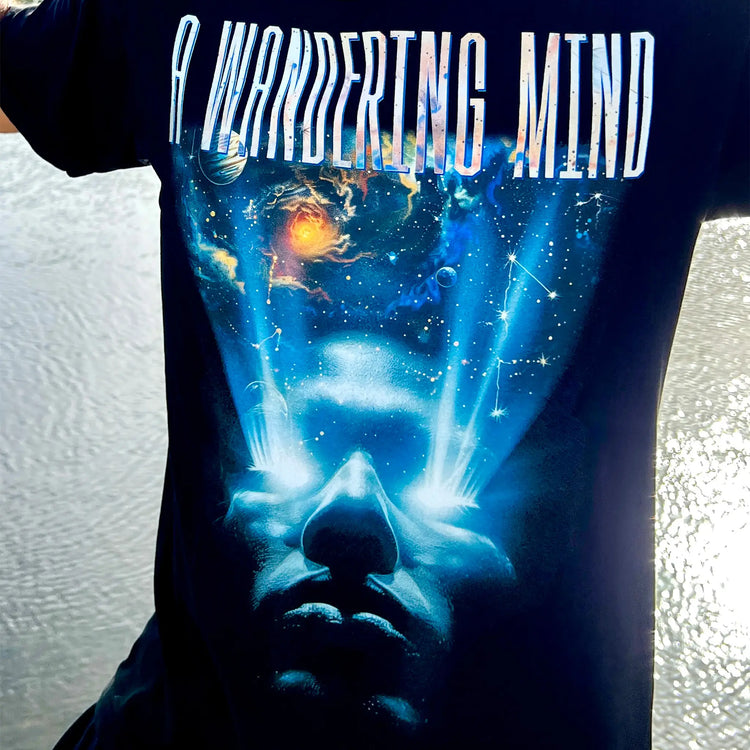 A Wandering Mind Awakening t-shirt in black front graphic featuring face, light beams, cosmic scene