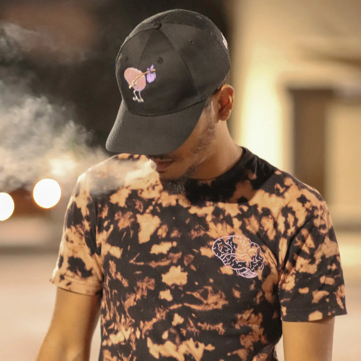 A Wandering Mind Classic Brain Pink Logo t-shirt in bleach-dyed black front view worn on model