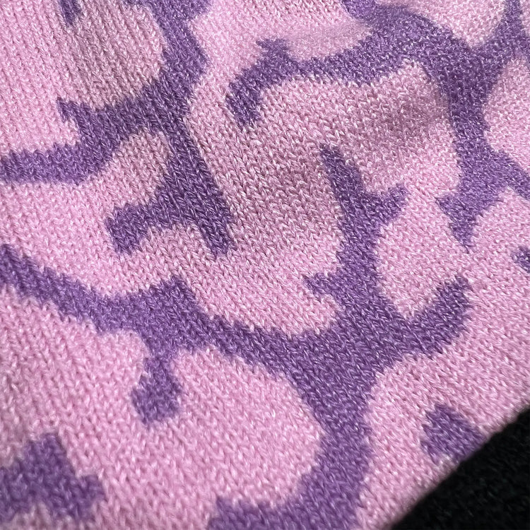 A Wandering Mind Brain beanie in violet showing jacquard brain pattern knit detail