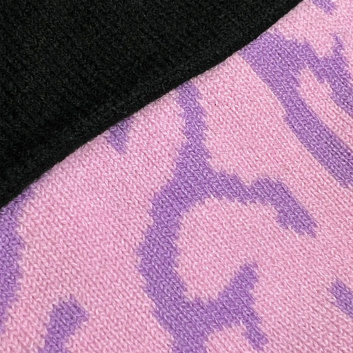 A Wandering Mind Brain beanie in violet showing jacquard brain pattern knit detail