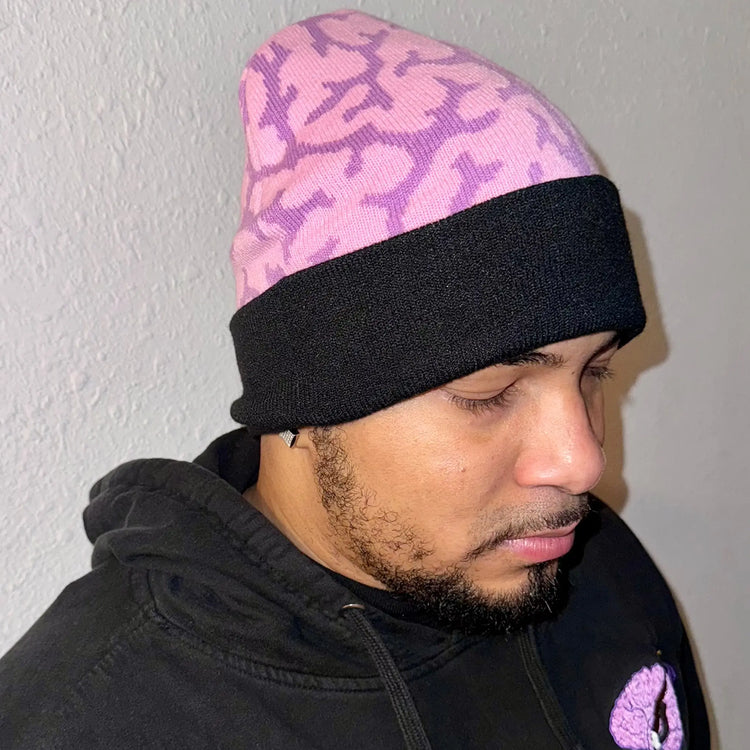 A Wandering Mind Brain beanie in violet back view worn on model