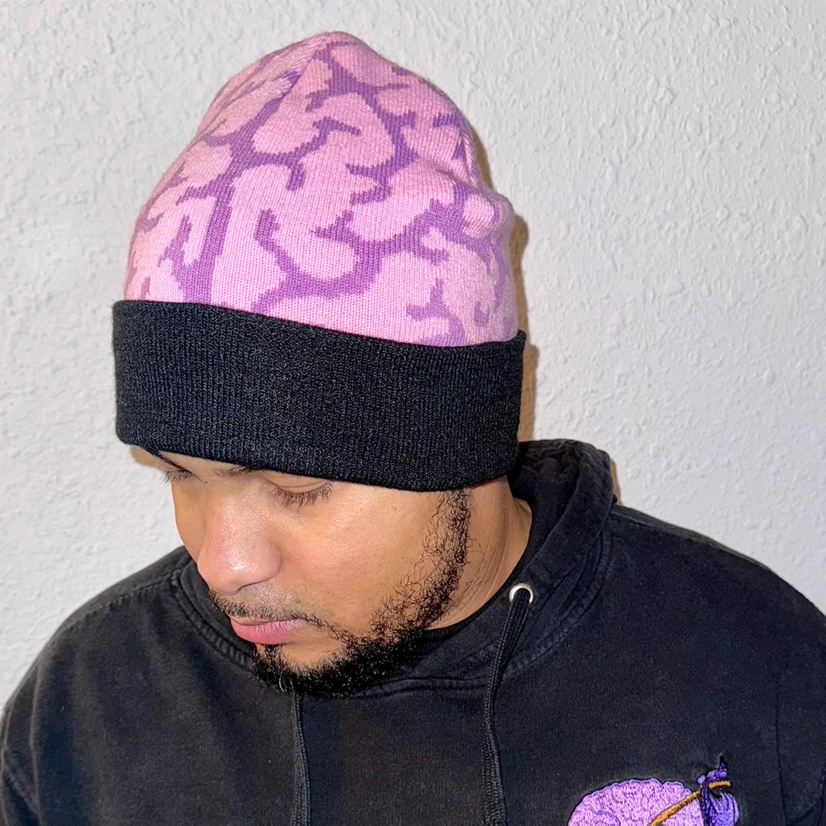 A Wandering Mind Brain beanie in violet front view worn on model