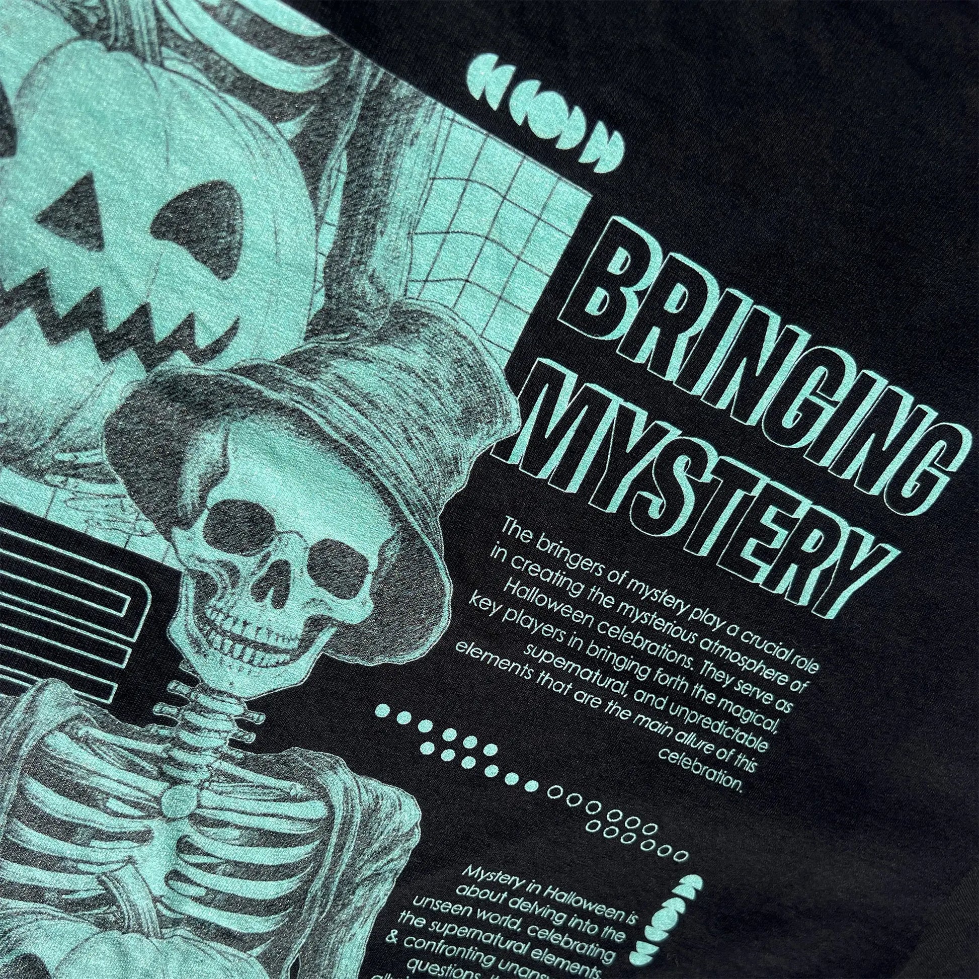 A Wandering Mind Bringing Mystery t-shirt in black back graphic detail showing skeletal figure, jack-o’-lantern, grid layout