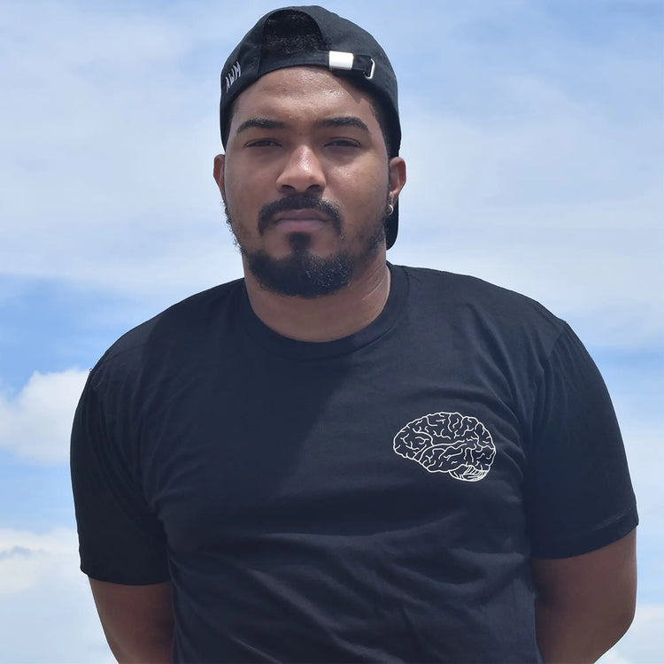 A Wandering Mind Classic Brain White Logo t-shirt in black front view worn on model