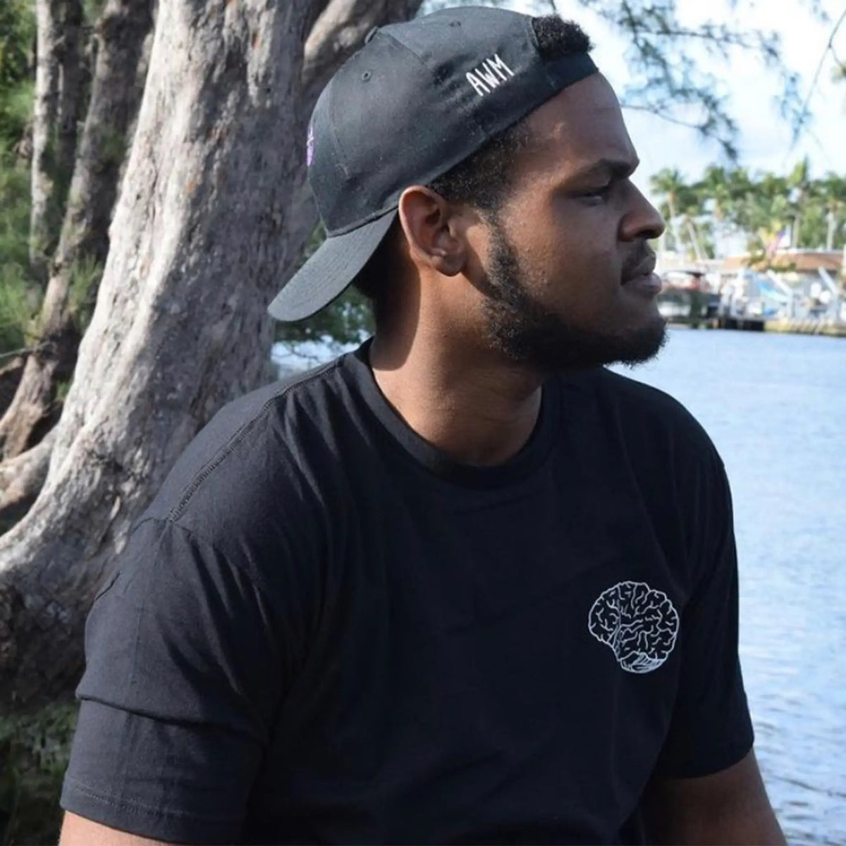 A Wandering Mind Classic Brain White Logo t-shirt in black side view worn on model
