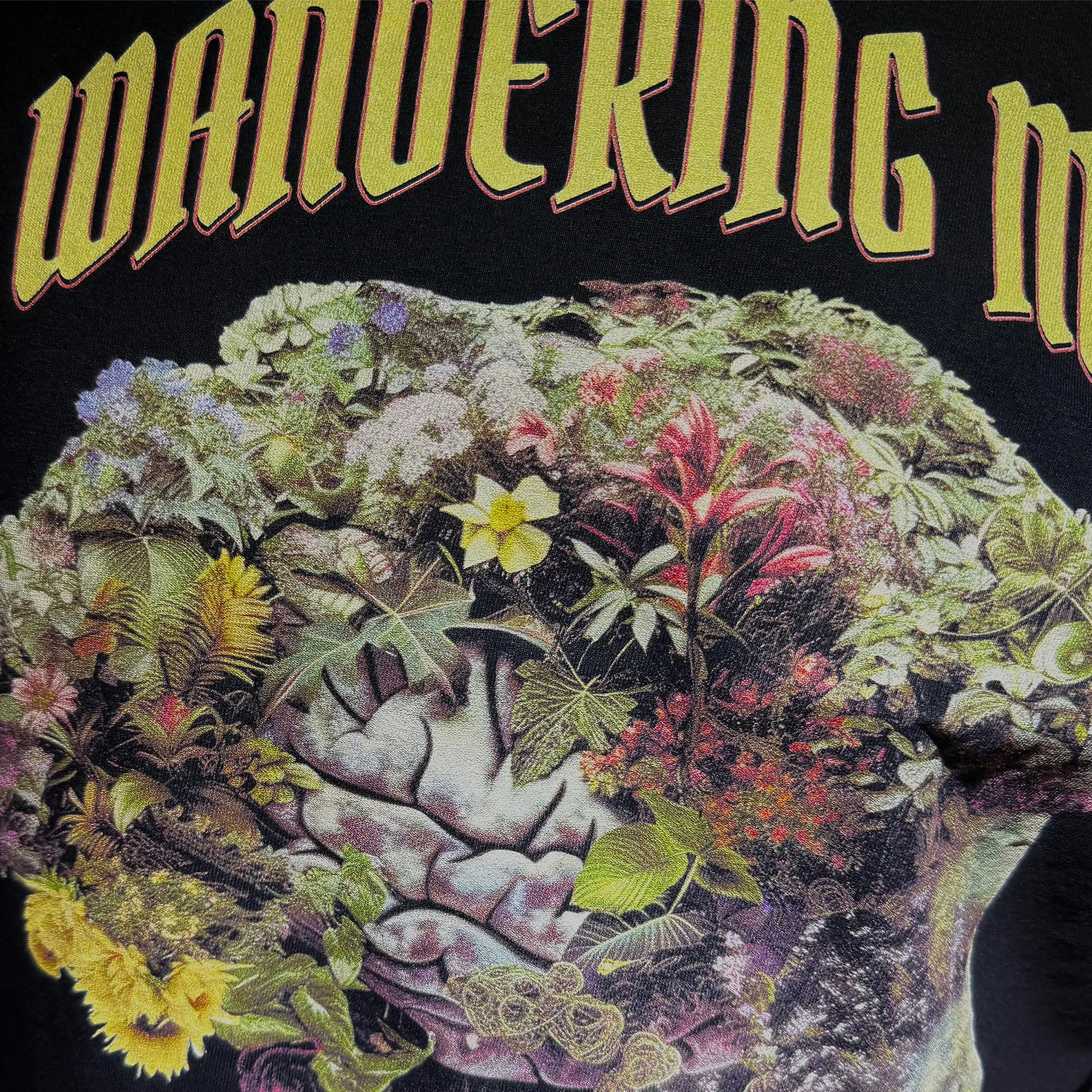 A Wandering Mind Cognitive Flora long sleeve t-shirt in black front graphic detail showing human profile, floral brain