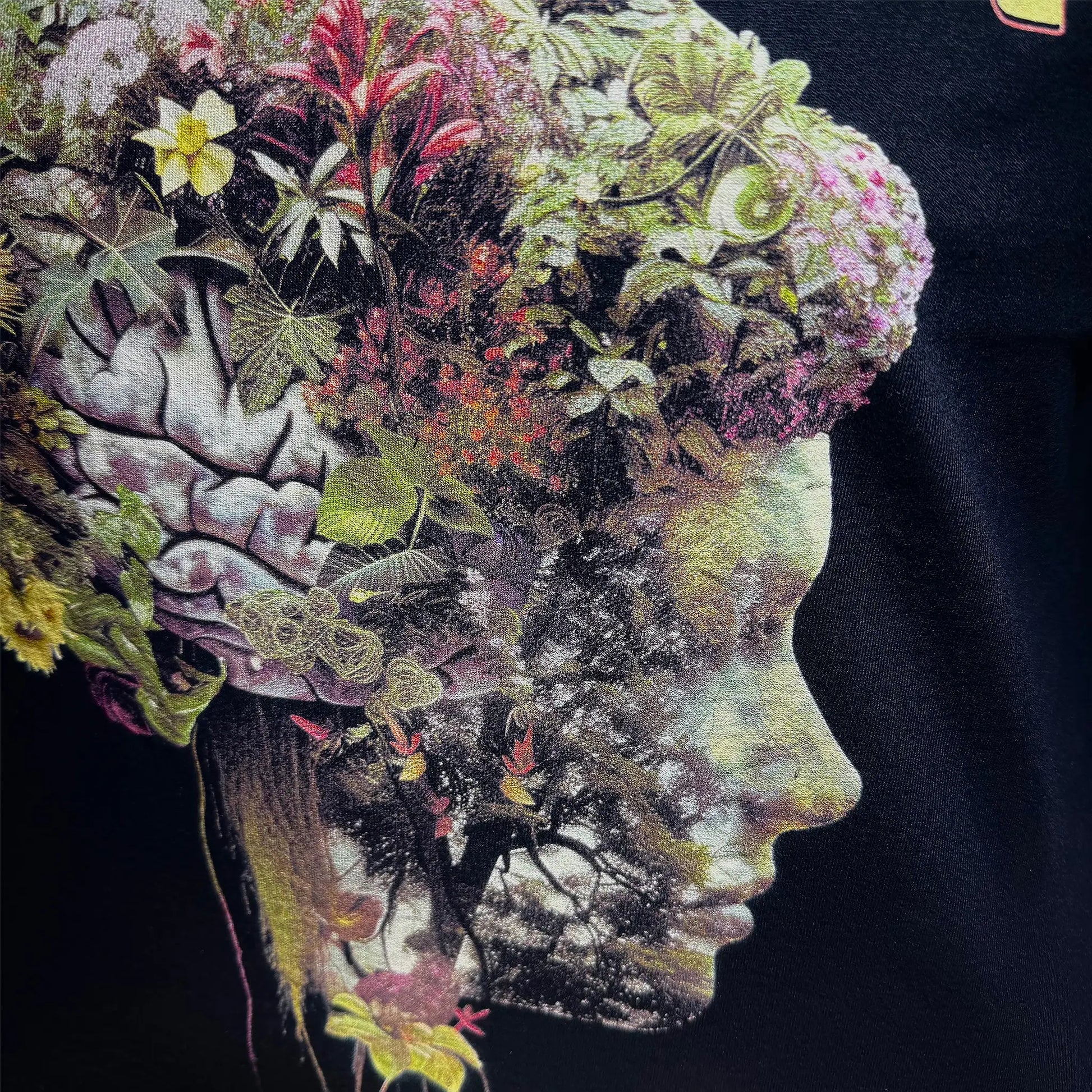 A Wandering Mind Cognitive Flora long sleeve t-shirt in black front graphic detail showing human profile, floral brain