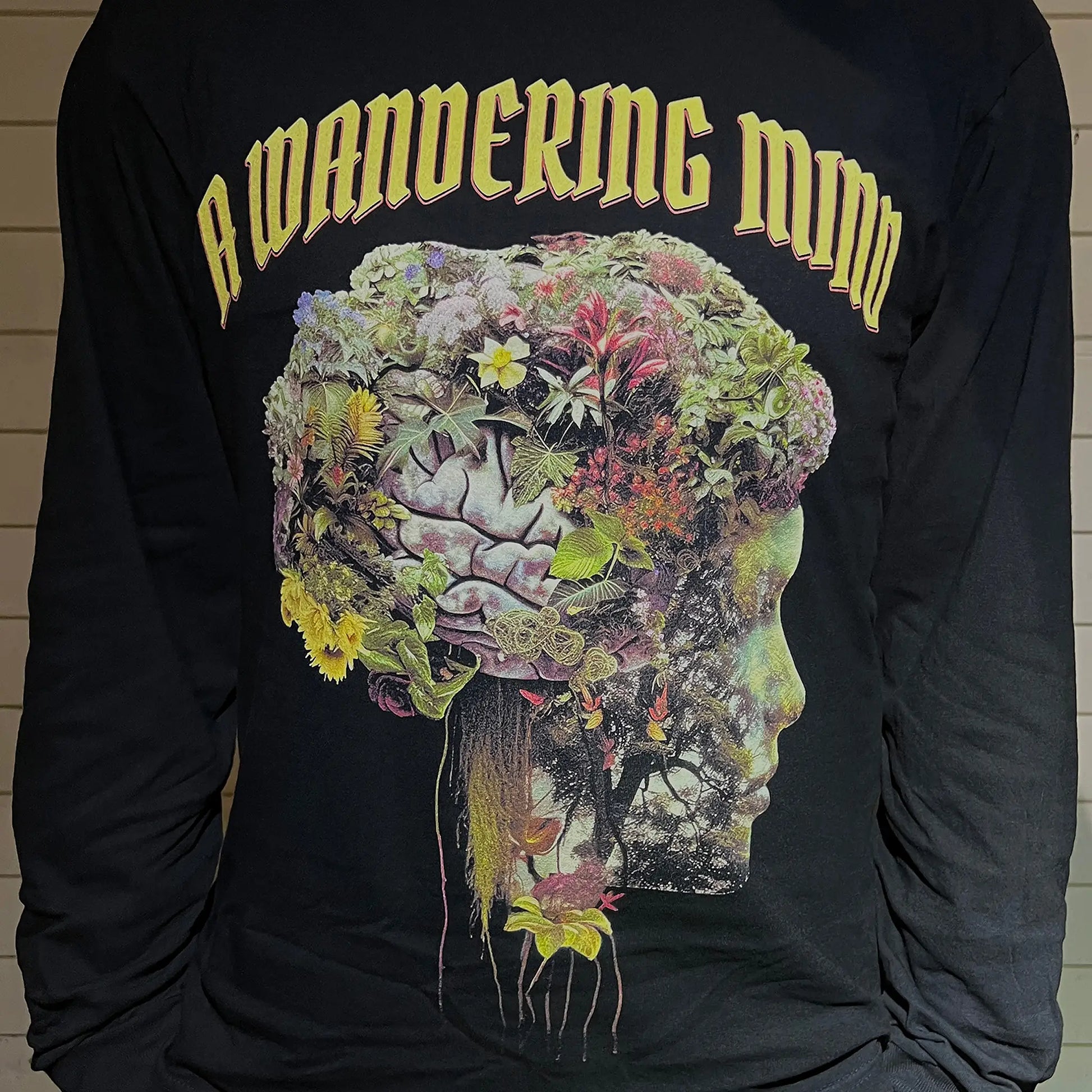 A Wandering Mind Cognitive Flora long sleeve t-shirt in black front view worn on model