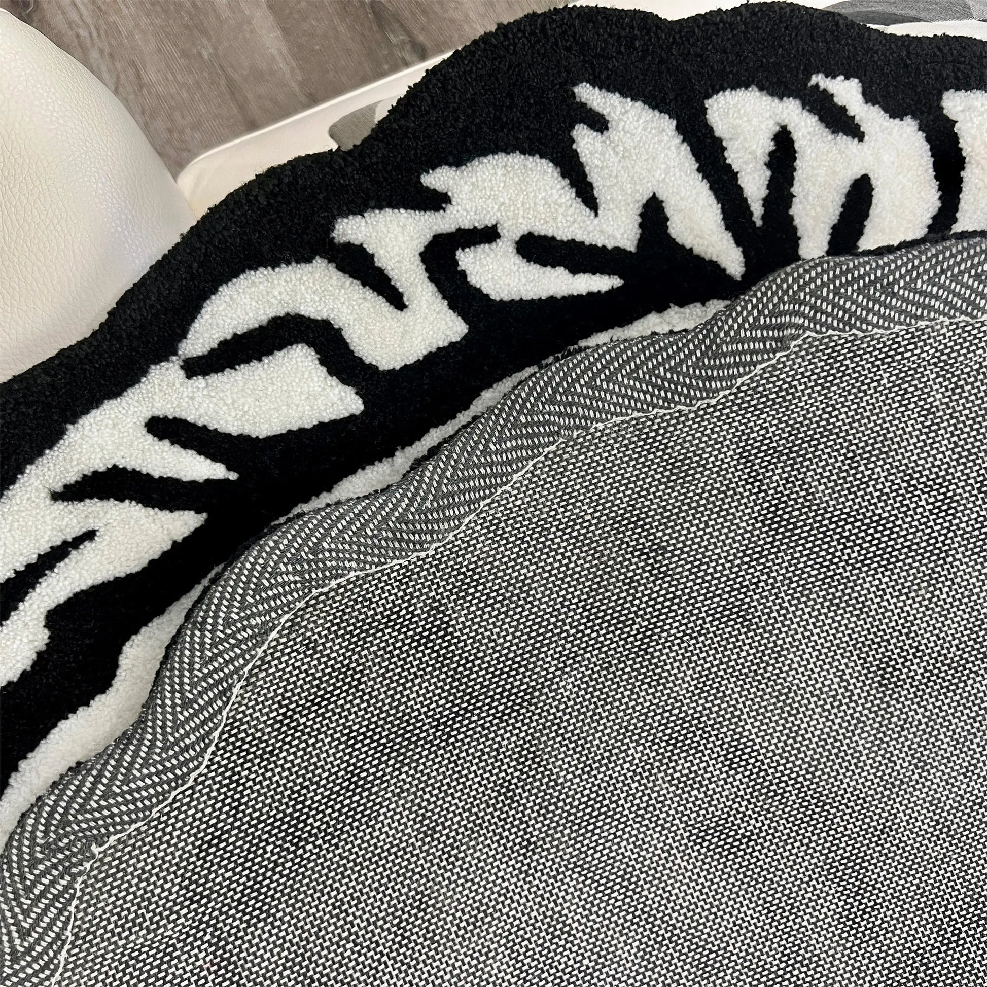 A Wandering Mind Divided Self rug in black and white edge detail