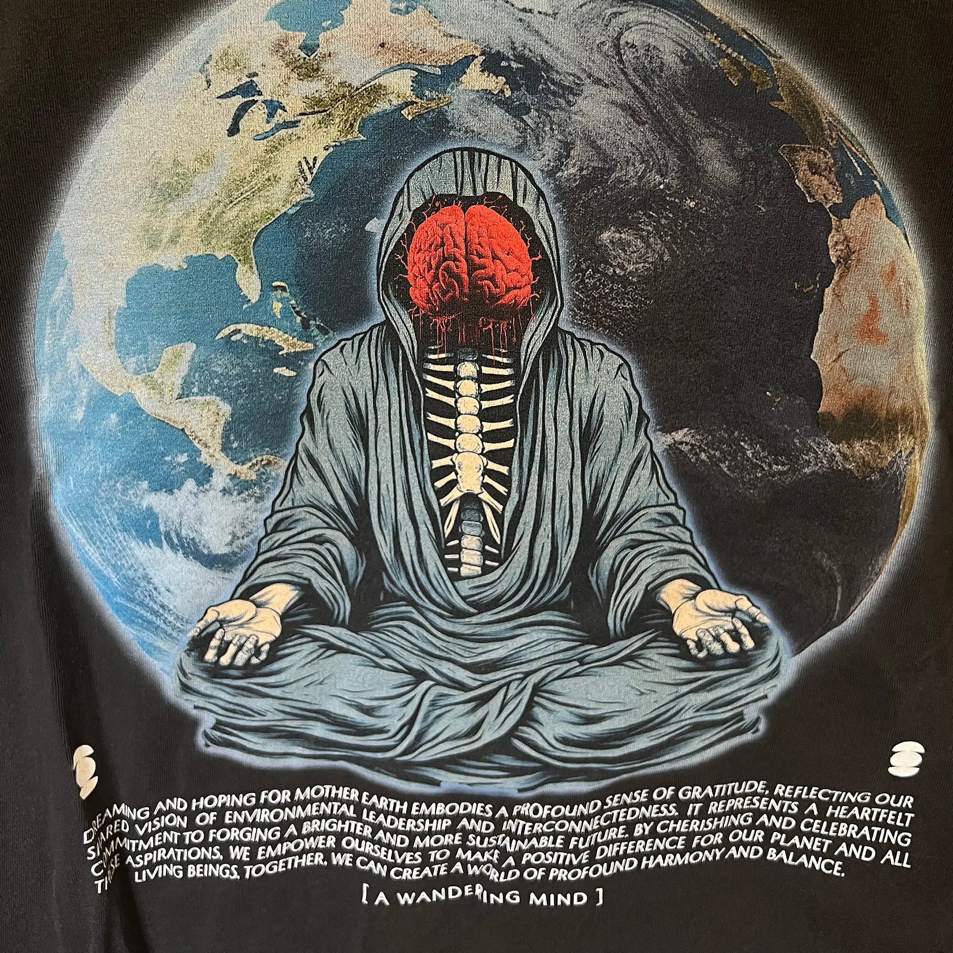 A Wandering Mind Dreams and Hopes long sleeve t-shirt in vintage black front graphic detail featuring robed figure, exposed brain, globe