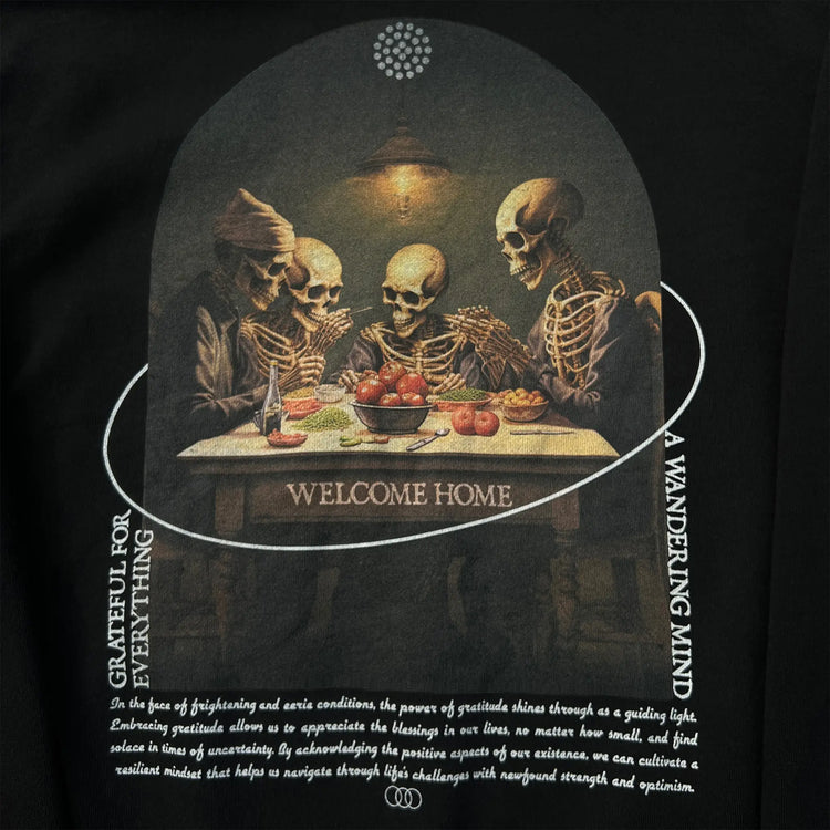 A Wandering Mind Grateful for Everything hoodie in black back graphic detail print texture showing skeletons at table, food, interior scene