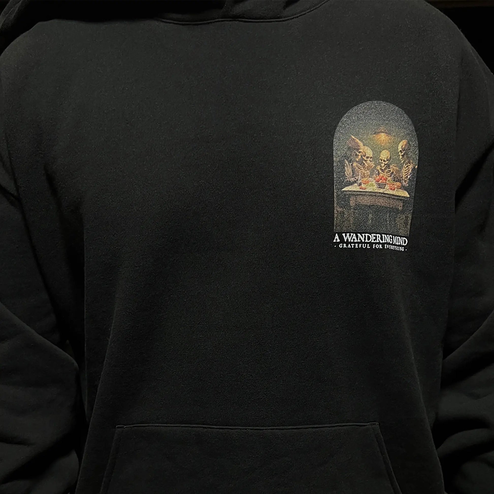 A Wandering Mind Grateful for Everything hoodie in black front view worn on model