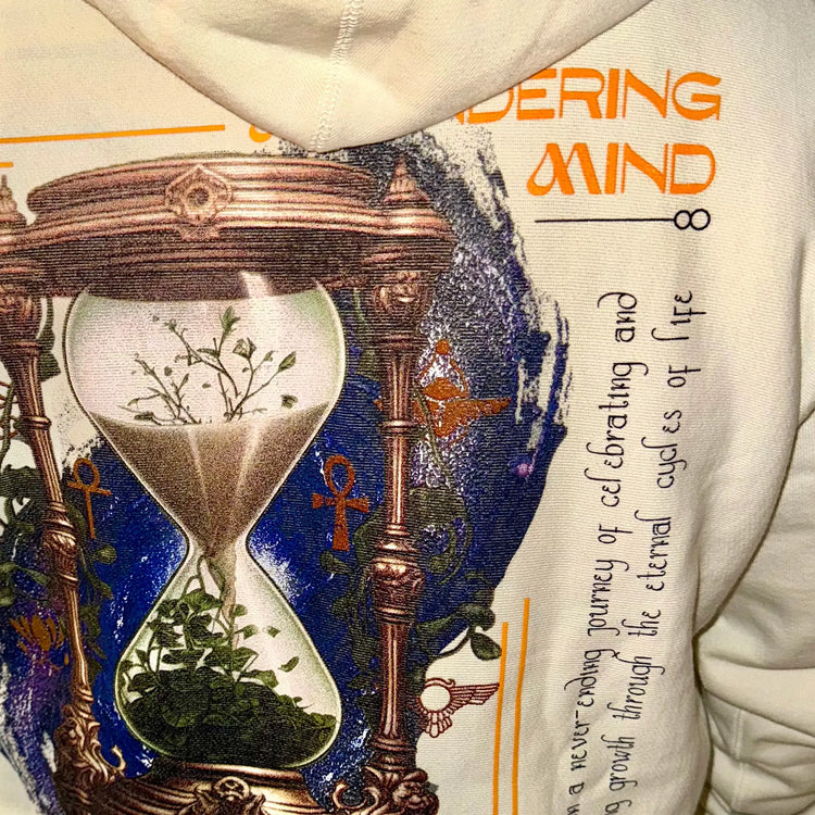 A Wandering Mind Growth and Renewal hoodie in bone back graphic view of hourglass, foliage, symbolic elements