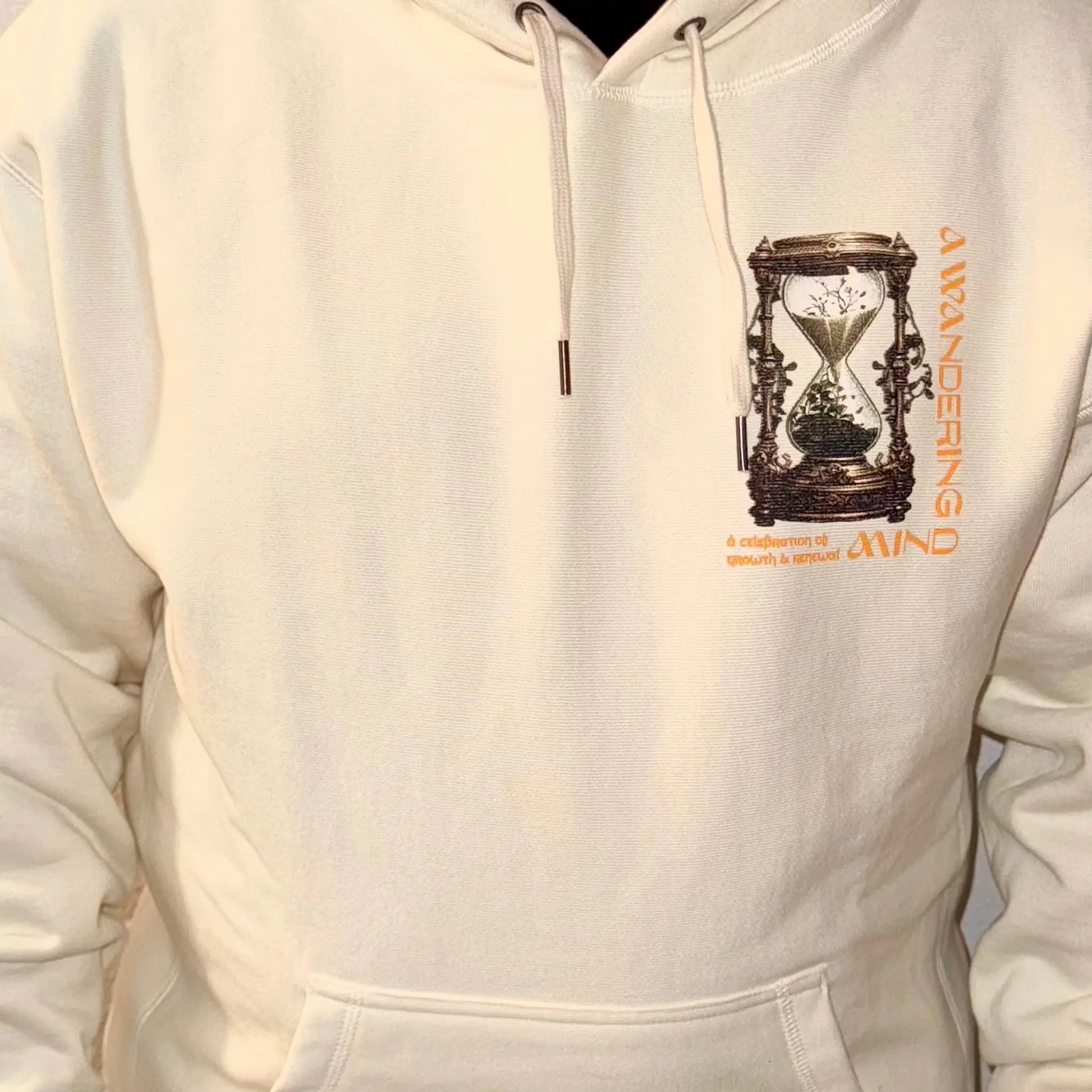 A Wandering Mind Growth and Renewal hoodie in bone front view worn on model