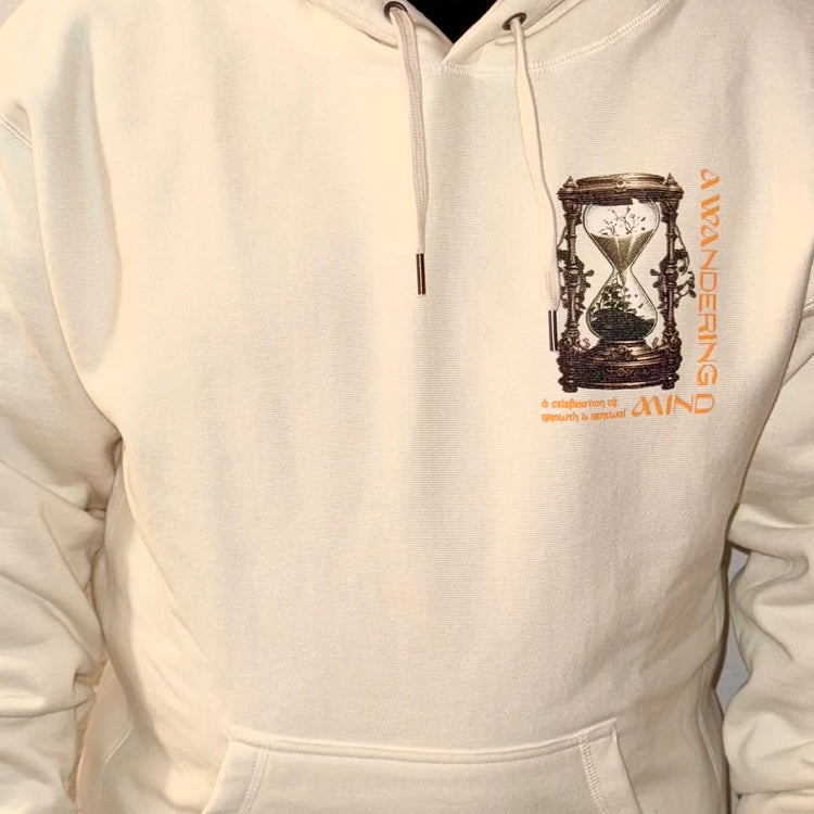 A Wandering Mind Growth and Renewal hoodie in bone front view worn on model