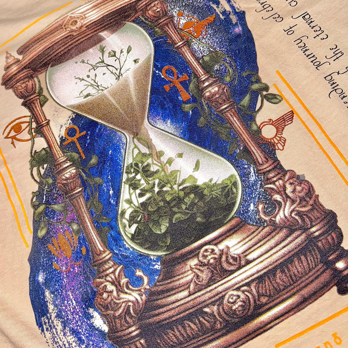 A Wandering Mind Growth & Renewal t-shirt in sand back graphic detail showing hourglass, foliage, symbolic elements