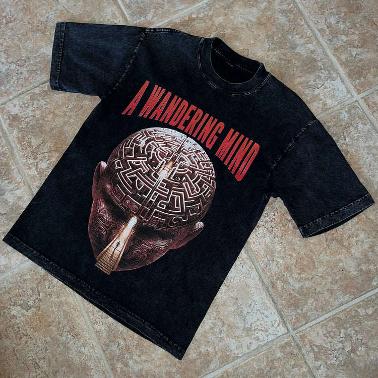 A Wandering Mind Mindful Maze t-shirt in washed black front graphic angled view of human head maze, staircase