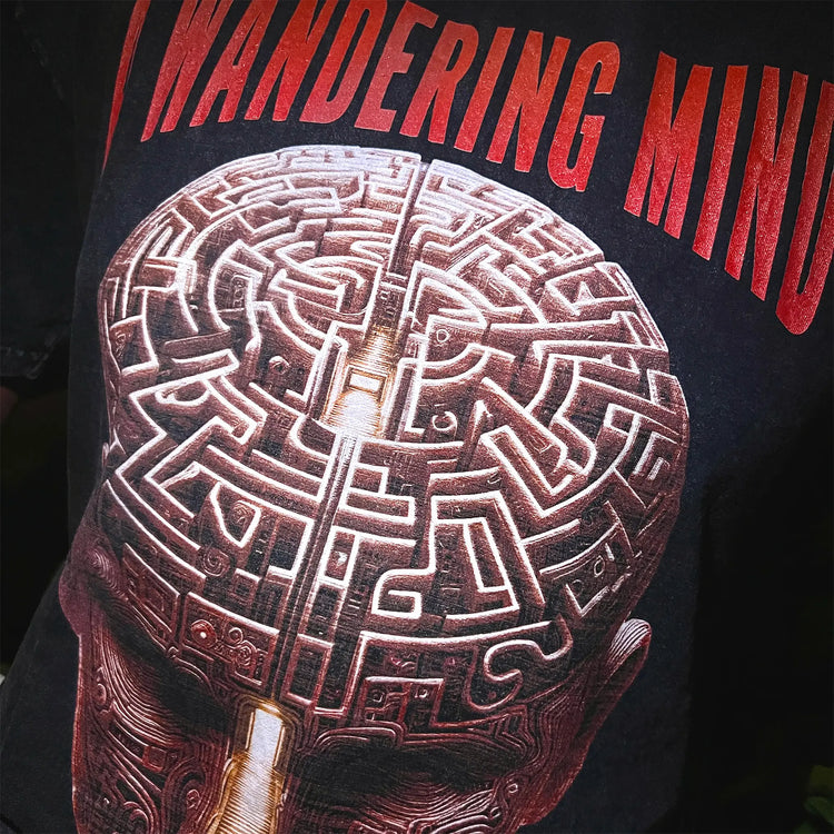 A Wandering Mind Mindful Maze t-shirt in washed black front graphic detail showing human head maze, staircase worn on model