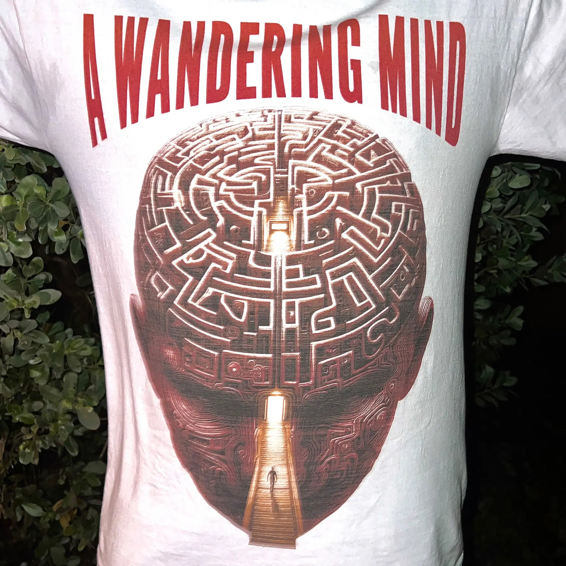 A Wandering Mind Mindful Maze t-shirt in white front graphic featuring human head maze, staircase