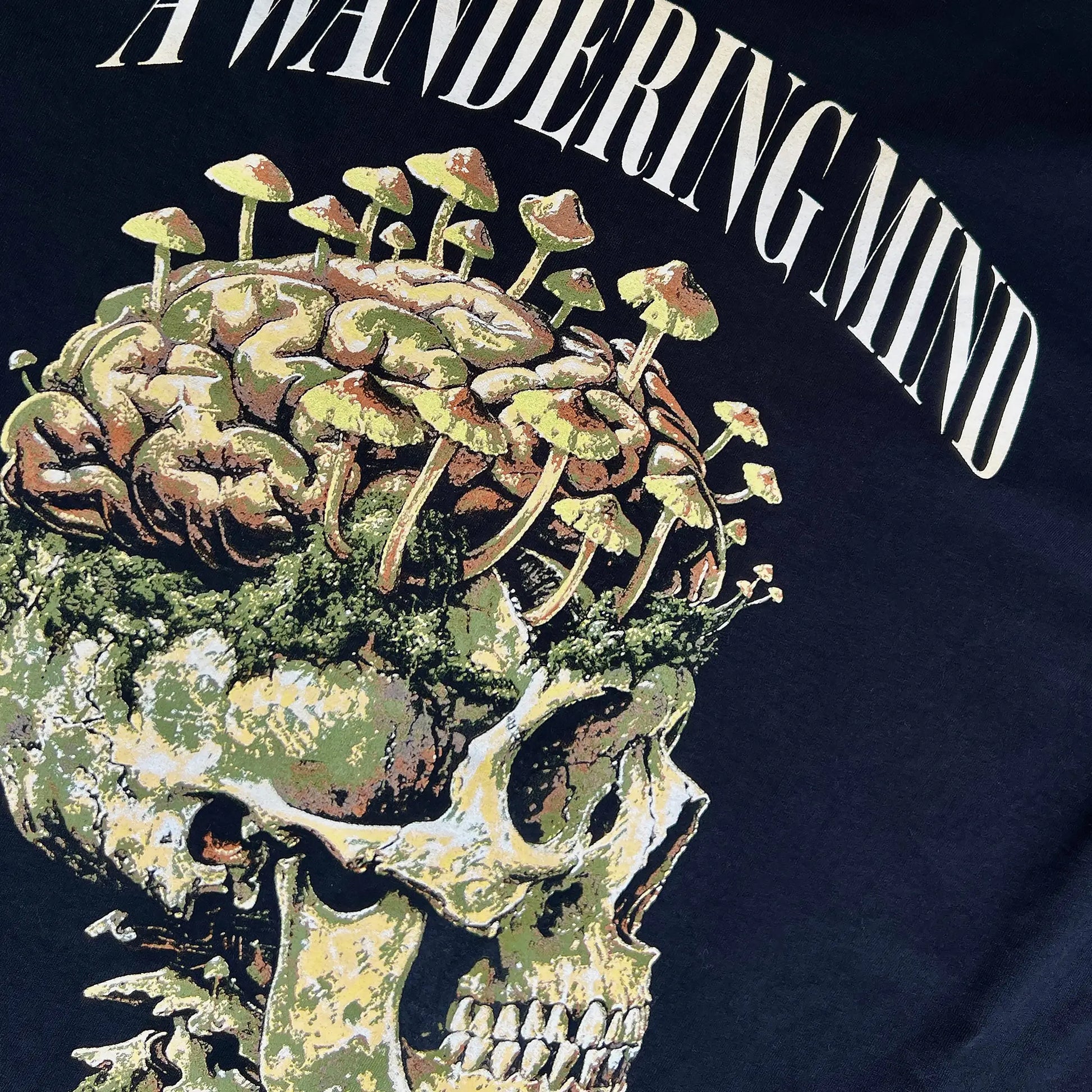 A Wandering Mind Rebirth hoodie in black back graphic angled view of skull, mushrooms, moss