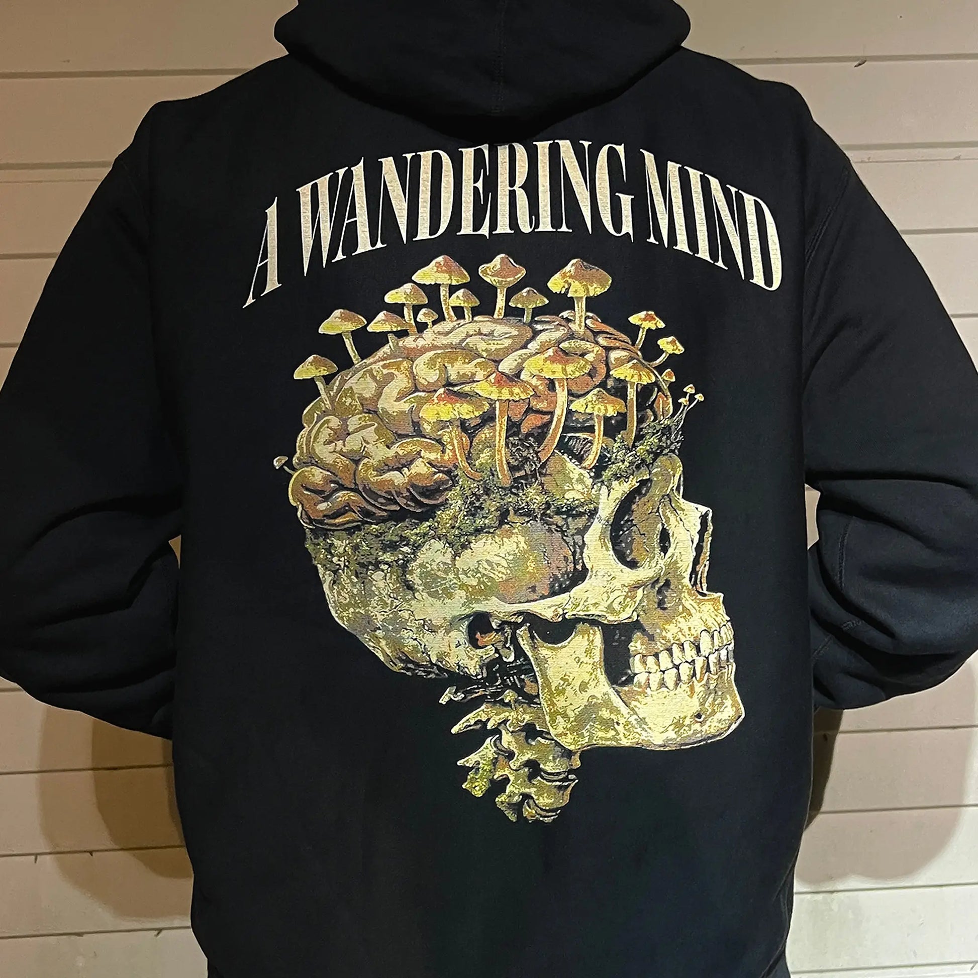 A Wandering Mind Rebirth hoodie in black back view worn on model