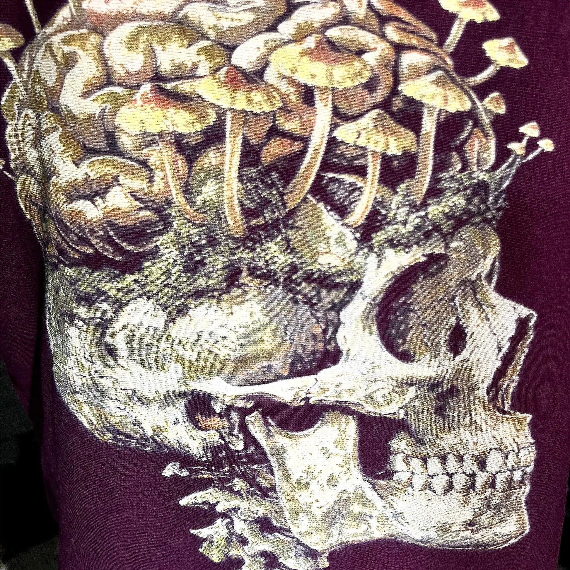 A Wandering Mind Rebirth hoodie in maroon back graphic detail print texture showing skull, mushrooms, moss