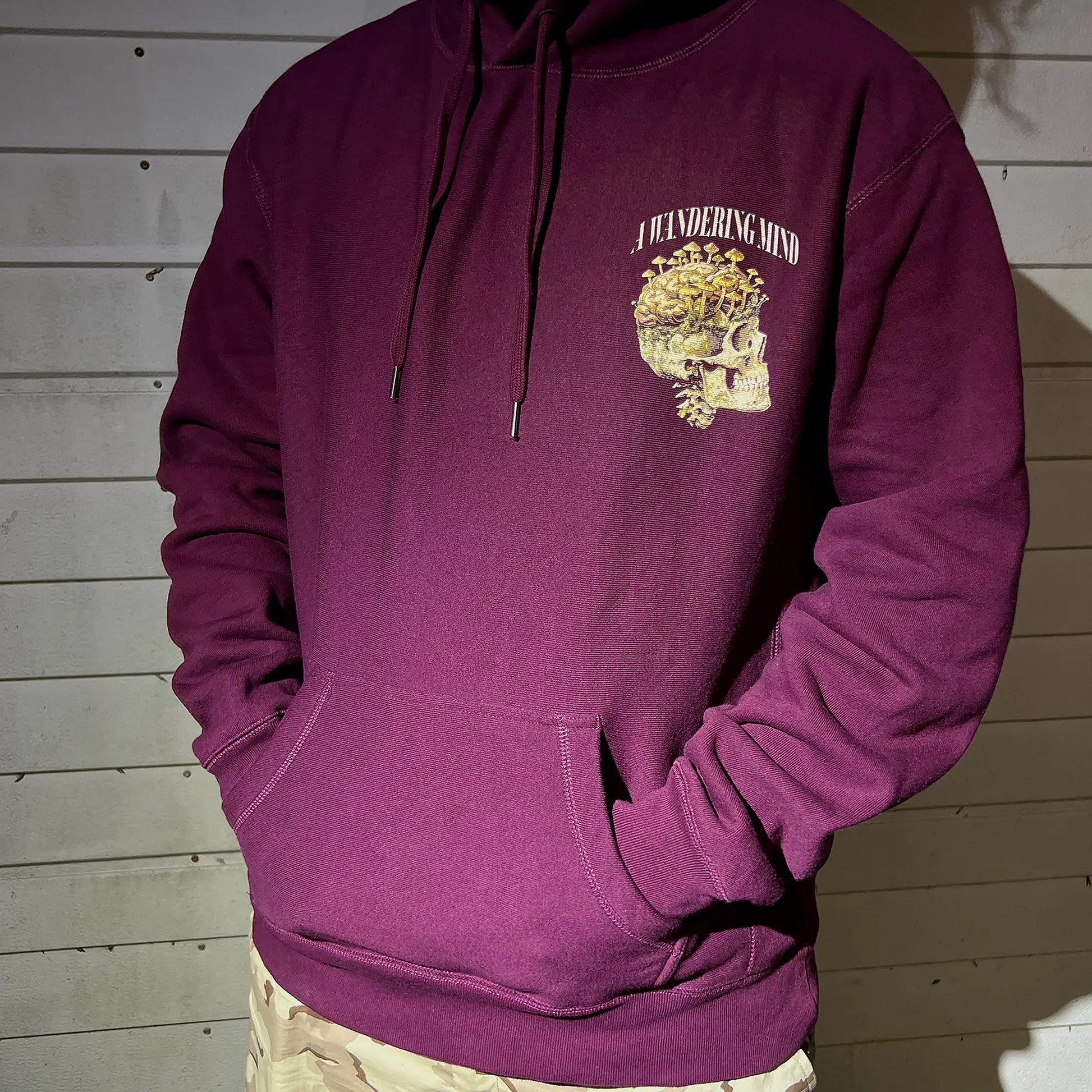 A Wandering Mind Rebirth hoodie in maroon front view worn on model