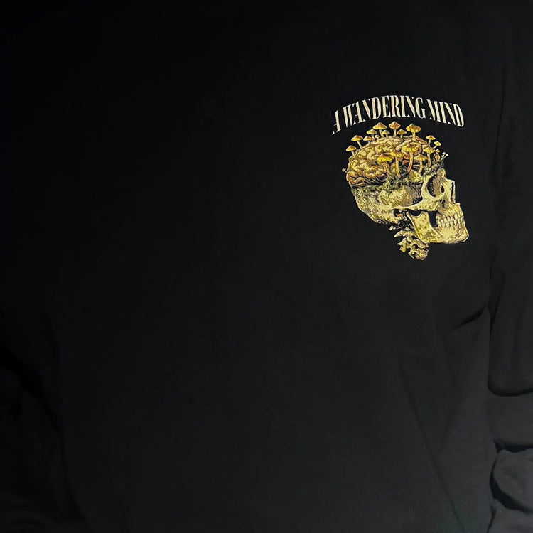 A Wandering Mind Rebirth long sleeve t-shirt in black front graphic detail showing skull, mushrooms, moss