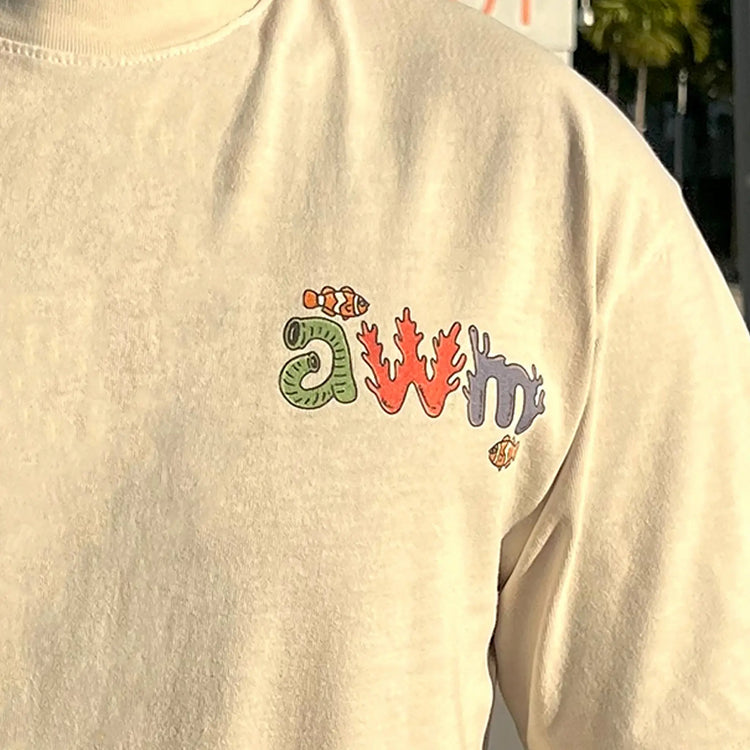 A Wandering Mind Arid Thoughts t-shirt in bone front graphic detail showing clownfish, reef typography, sea life