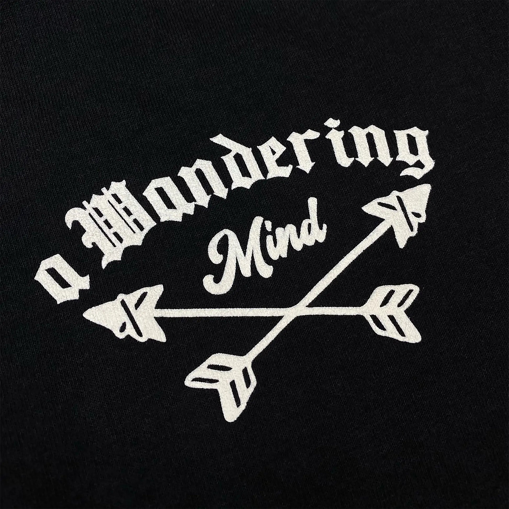 A Wandering Mind The Wolf t-shirt in black front graphic detail showing typography and arrows