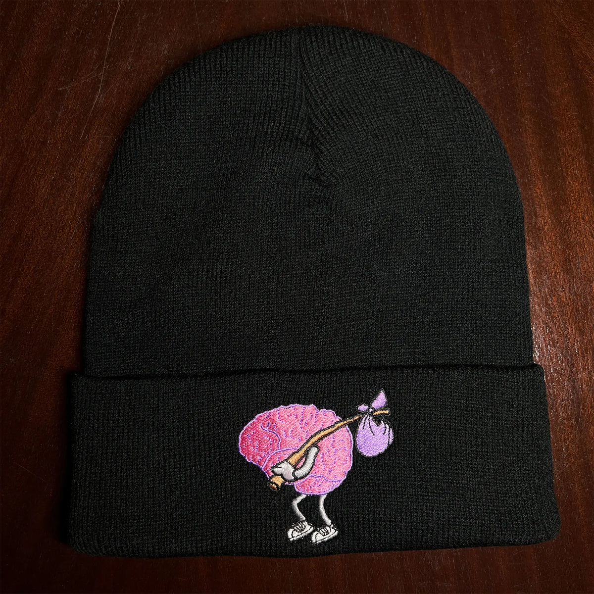 A Wandering Mind Wandering beanie in black embroidered logo detail featuring wandering brain character