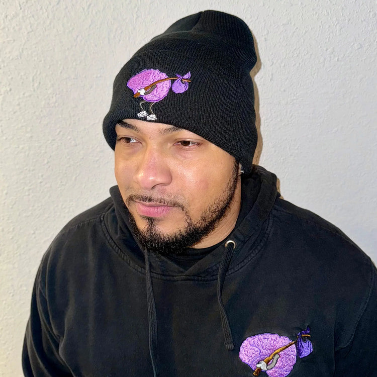 A Wandering Mind Wandering beanie in black side view worn on model