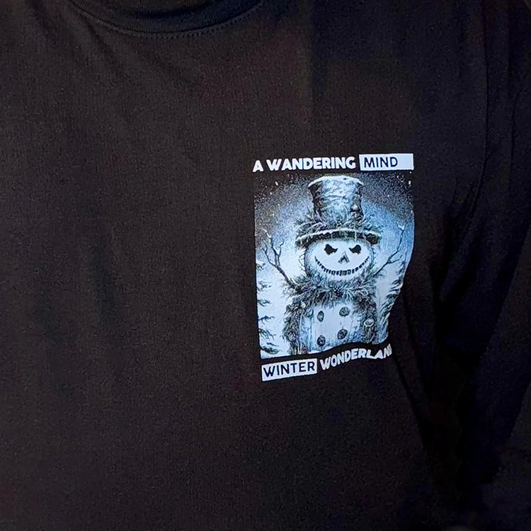 A Wandering Mind Winter Wonderland t-shirt in black front graphic detail showing snowman with smiling face, winter elements